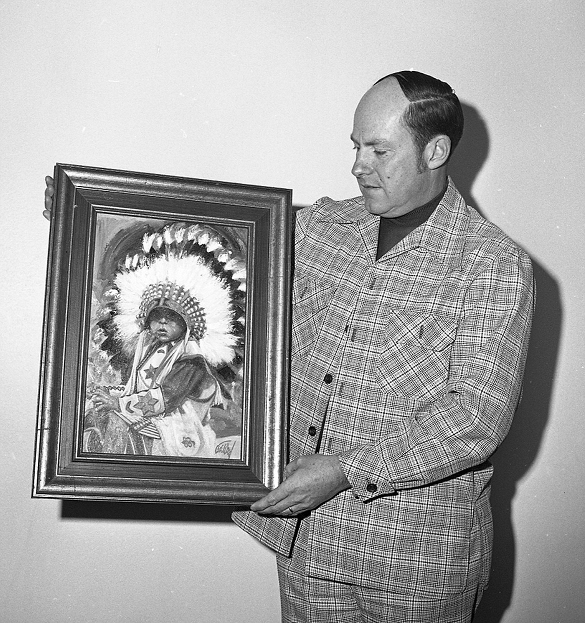 NEIL ELIASON won the fourth Great Chief award from the Kalispell Chamber of Commerce in 1975. Here he proudly displays the Geri Wood oil painting named &#147;Little Chief&#148; that he was honored with. (Inter Lake file photo/Sarah Taylor)
