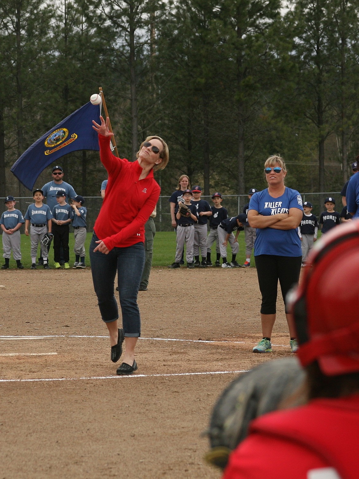 Sandpoint&#146;s Sabrina Higdon throws out the ceremonial first pitch during the opening day celebration for Sandpoint Little League on Saturday at Travers Park. Hundreds of players and hundreds more spectators were on hand for the event, with plenty of baseball and softball action. Higdon was honored after starting a memorial fund in her late husband Ken Higdon&#146;s name, with all proceeds benefiting Sandpoint Little League. For more on Ken Higdon, who worked in Major League Baseball for more than 30 years, or to make a donation to the fund, visit Sandpoint LittleLeague.com.
(Photo by ERIC PLUMMER)