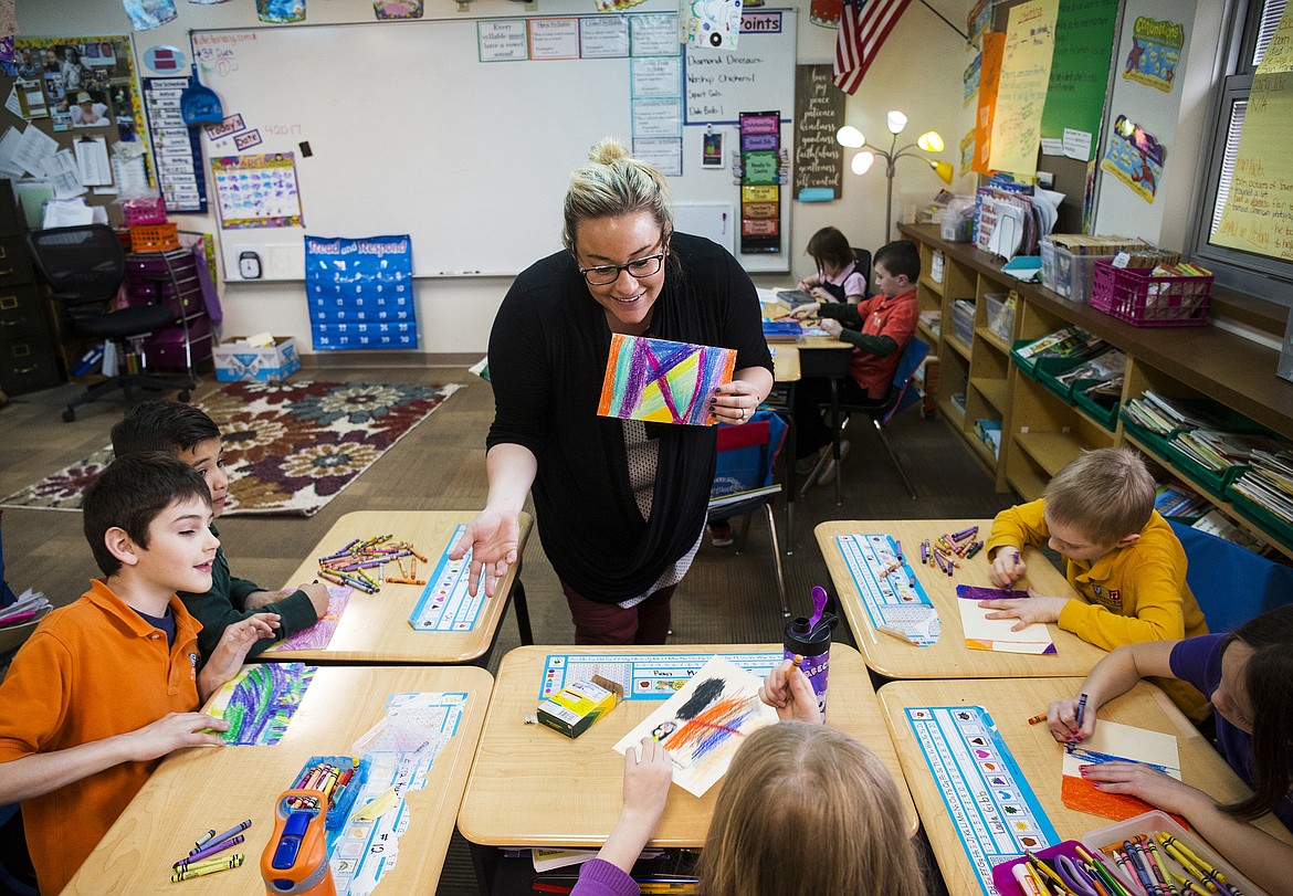 LOREN BENOIT/Press
Kathleen Corbeill, a second-grade teacher at Sorensen Magnet School of the Arts and Humanities, helps her students incorporate family heritage and immigration into their scratch artwork Thursday afternoon at school.