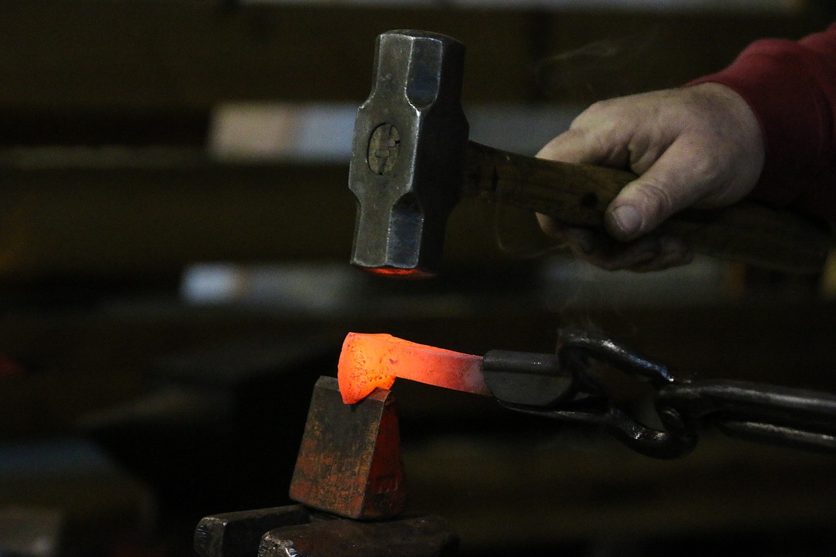 &#151;Photo by MANDI BATEMAN
Grant Marcoux transforms an old railroad spike into a knife display.