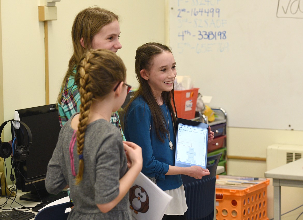 Home-schooled fifth-grader Makayla Davenport demonstrates the spelling app she coded with Cayuse Prairie fifth-grader Taylor Pooton and home-school fifth-grader Isabelle Ashley  during a presentation for Montana Code Girls at Russell Elementary on Thursday. (Aaric Bryan photos/Daily Inter Lake)
