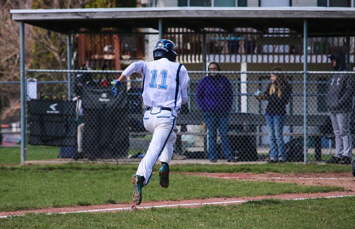 &#151; Photo by MANDI BATEMANSenior Raul Rodriquez sprinting home during a home game.