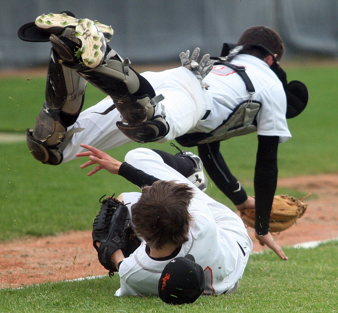 Rodney Harwood/Columbia Basin HeraldEphrata catcher Ethan Etter goes over the top of sliding pitcher Trent Kleyn to catch a popped up bunt to end the first game of Saturday's CWAC doubleheader Saturday against Othello.