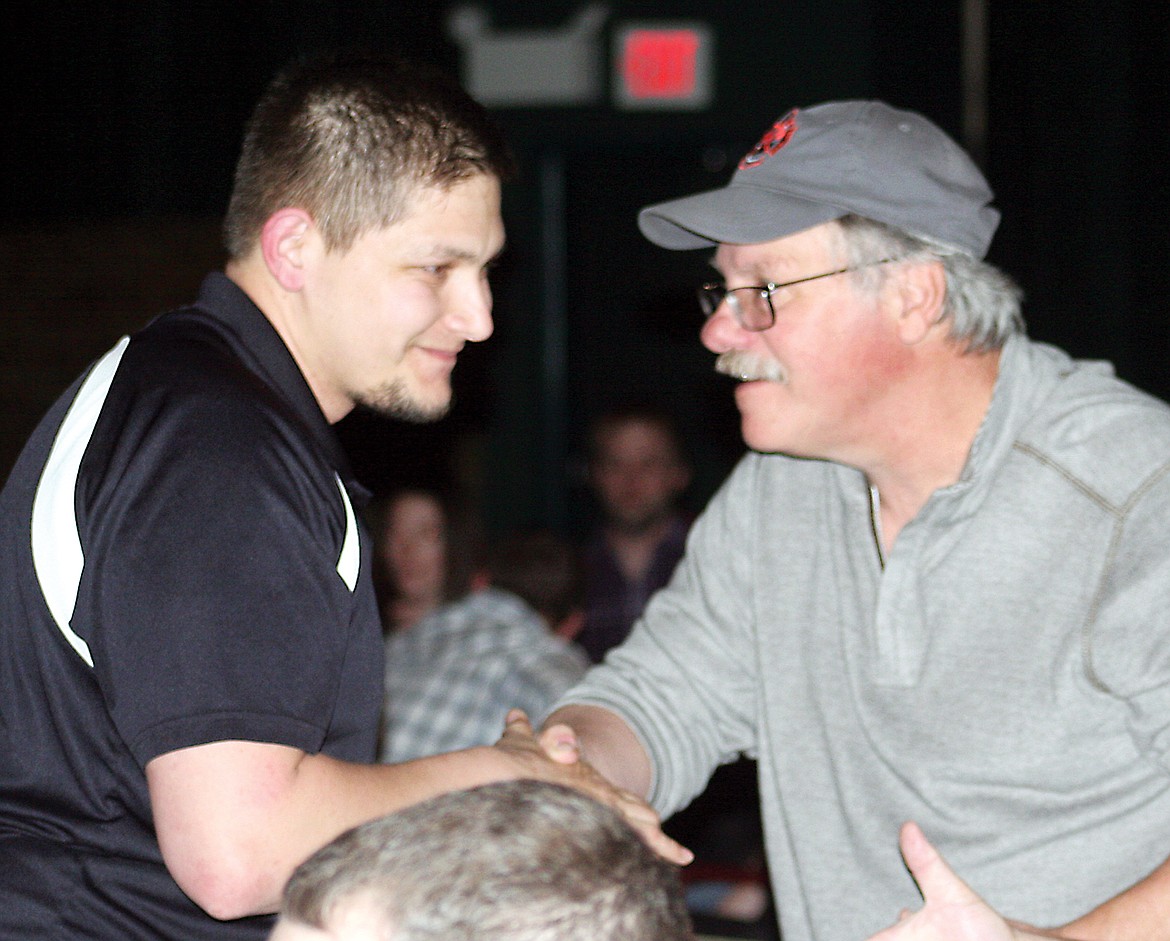 Andy Scott of Idaho Forest Group shakes hands with dealer Paul Resch after winning the $3,000 travel voucher during the ninth annual Northwest Community Health Center fundraiser dinner Saturday evening at the Memorial Event Center. (Elka Wood photos/TWN)