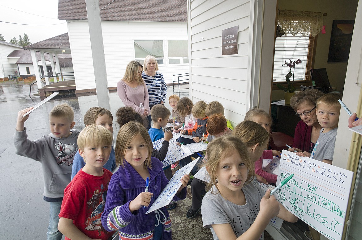 Kindergarten students at Deer Park do a &#147;needs assessment&#148; exercise while chatting with District Clerk Peggy Martin.