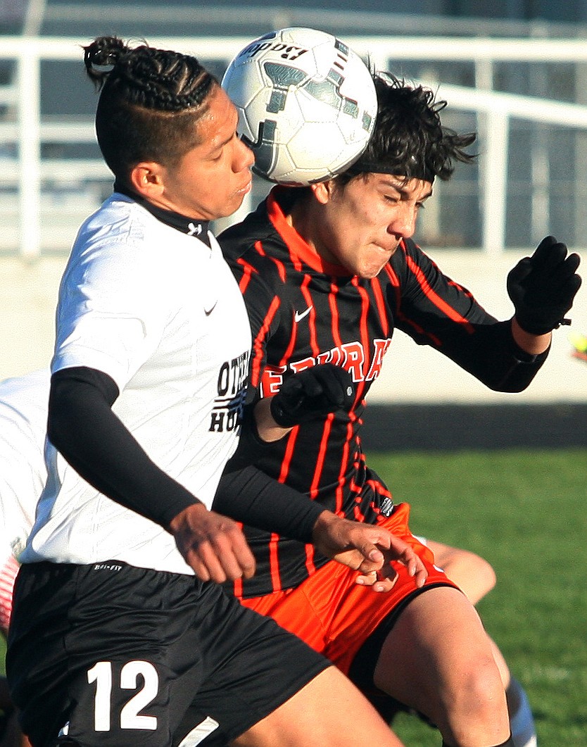 Rodney Harwood/Columbia Basin Herald - Othello's Jonathan Gutierrez (12) battles with Ephrata striker Luis Rodriguez for a ball at the midfield during CWAC action at Husky Stadium.