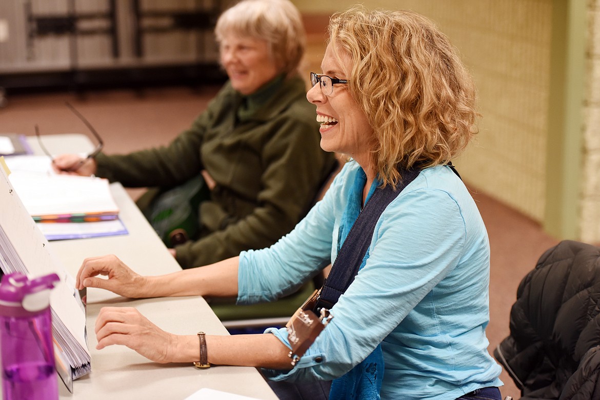 BETH SCREECHER and Scout Crawford share a laugh with the other members of their ukulele group at ImagineIf Library on Tuesday.
