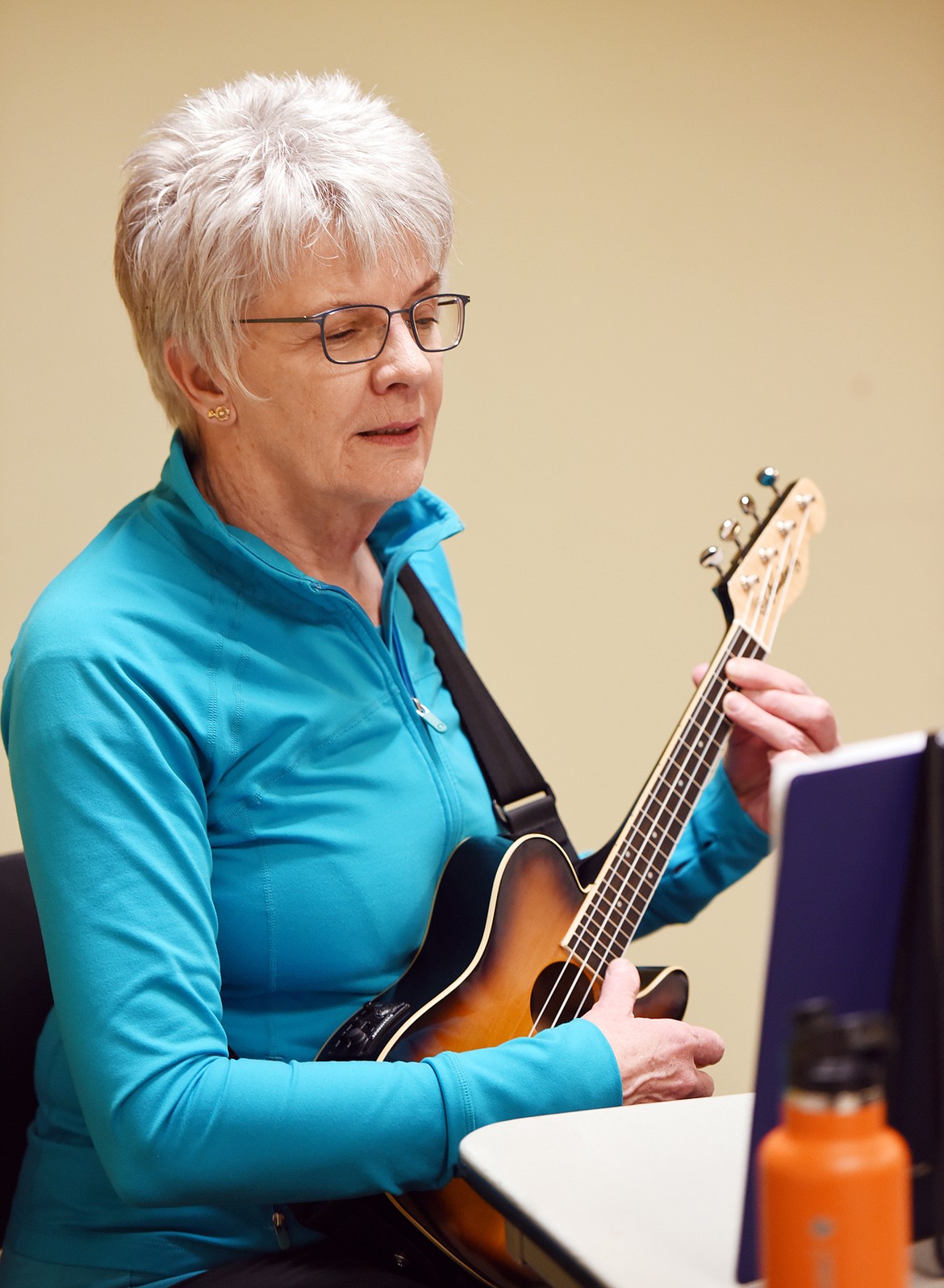 ROBIN RILEY and other ukulele strummers practice in the meeting room of ImagineIF Library Tuesday, April 18, in Kalispell.
(Brenda Ahearn/Daily Inter Lake)