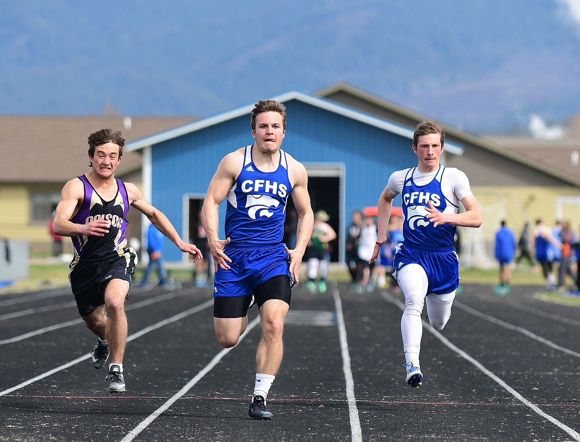 Braxton Reiten, center and Seth Gossett, right, run the 100 meters.