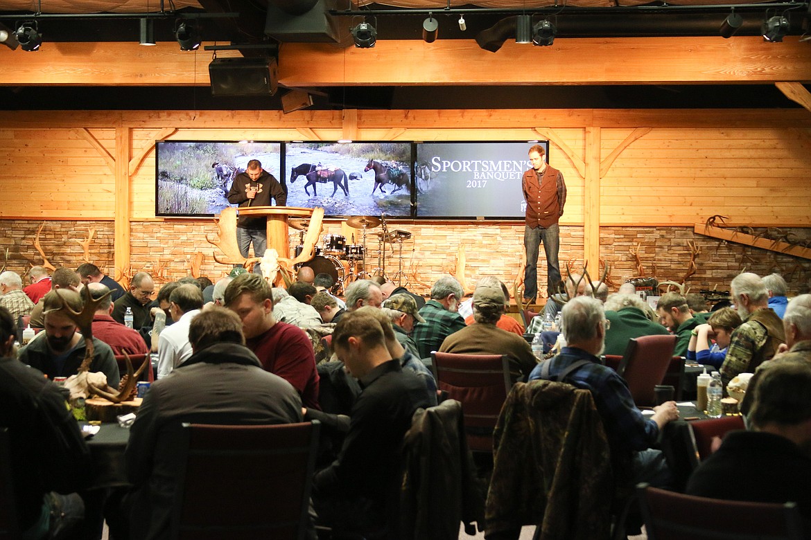 &#151;Photo by MANDI BATEMAN
A packed dining room takes part in prayer before dinner.