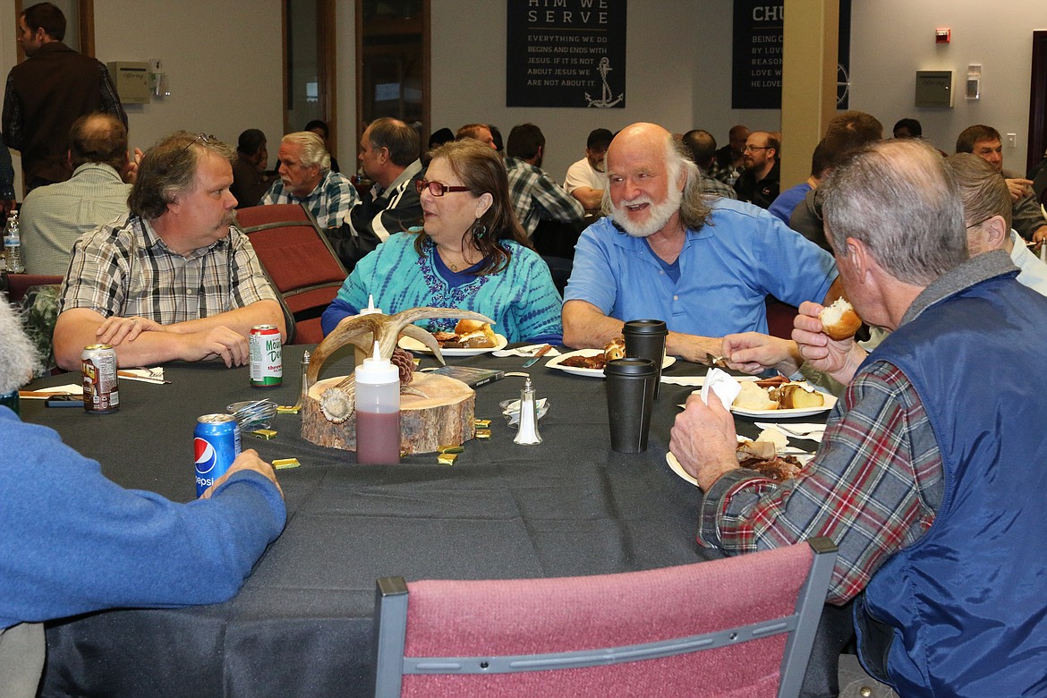 &#151;Photo by MANDI BATEMAN
Diners enjoy a slow smoked spare rib dinner provided by the former owners of the Rednek Pig BBQ.