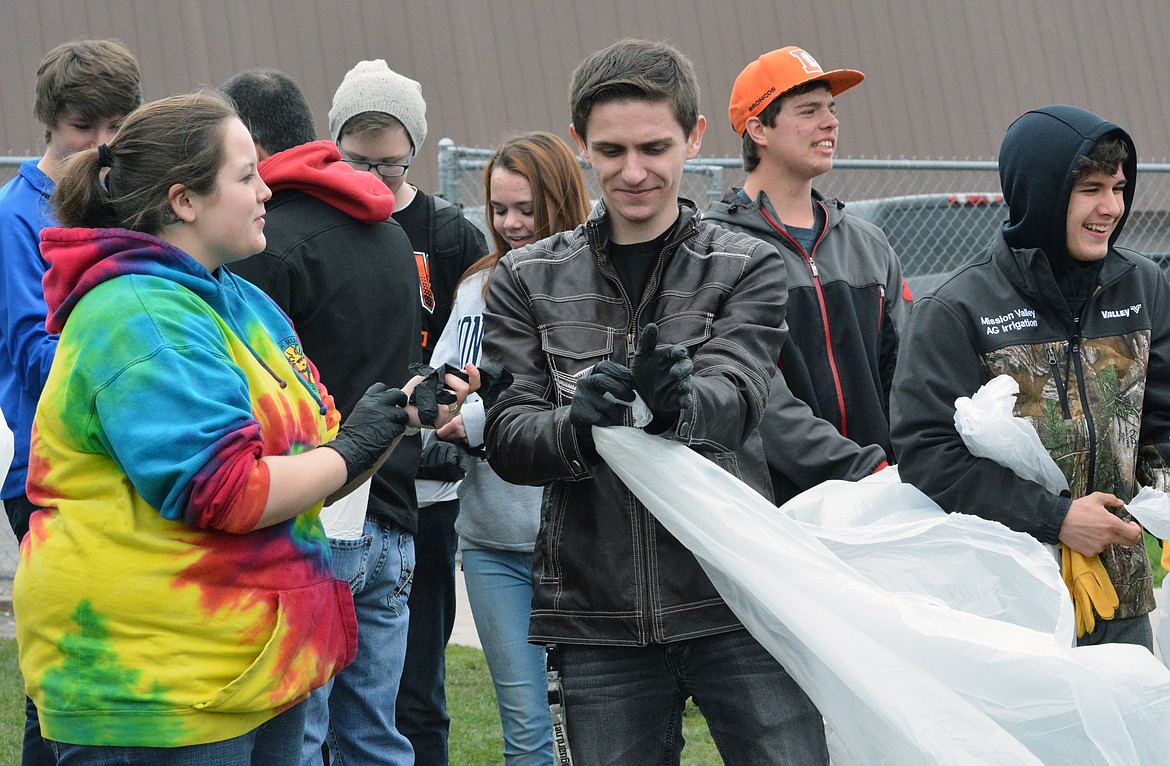 RONAN STUDENTS work together to pick up trash to commemorate Earth Day Wednesday at Ronan High School and the surrounding areas of the Ronan community. (Jason Blasco/Lake County Leader)