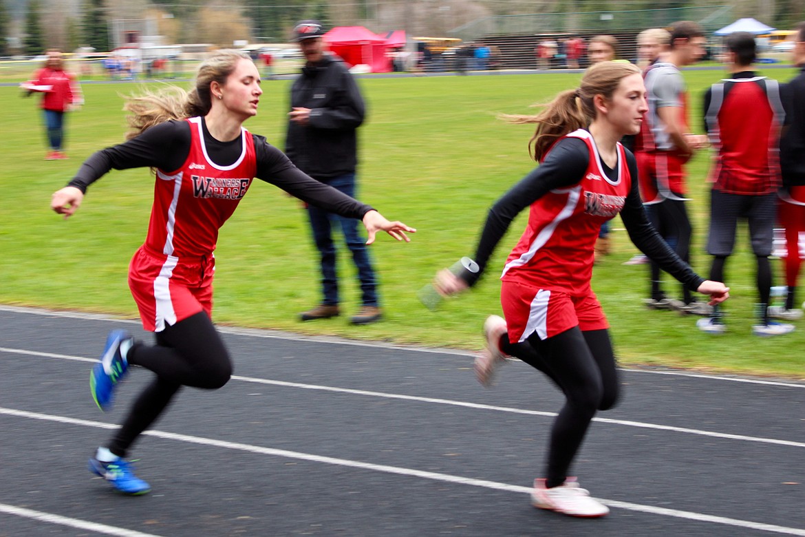 Abby Travis (left)&#160;hands of the baton to Catie Sheppard in the 4X100 relay. Wallace took first in this event with a time of 55.85.