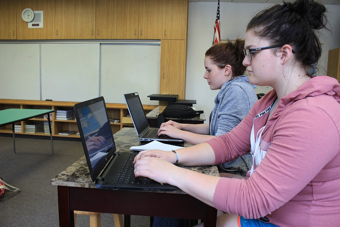 St. Regis students Gracie Shope and Virginia English work on their computers as part of the school&#146;s new Summit teaching platform. (Kathleen Woodford/Mineral Independent).