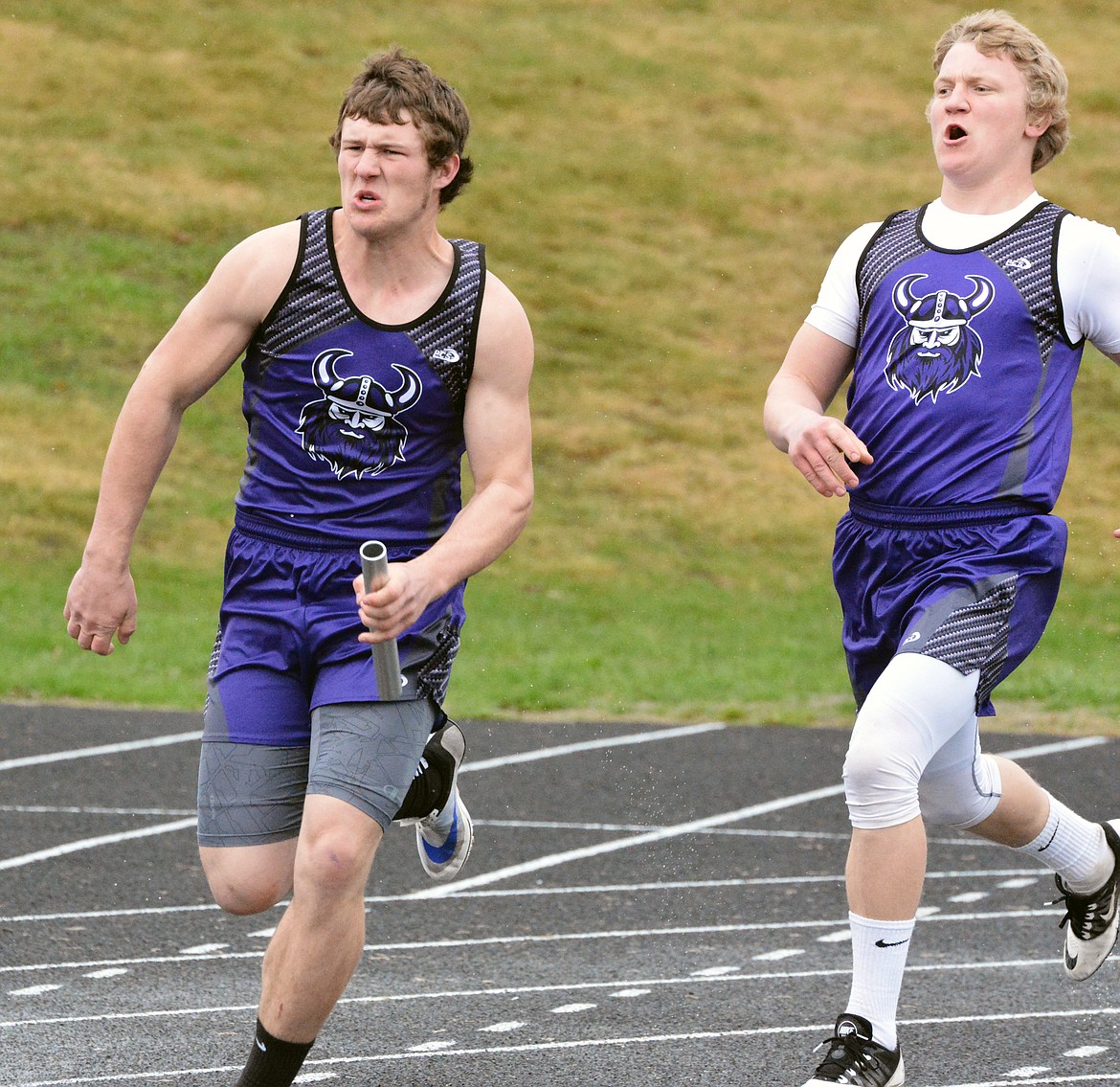 CHARLO RELAY runner Landers Smith accepts the handoff from Viking teammate Toby Odom Thursday afternoon in the Dave Tripp Memorial track meet. Smith won the 100-meter race with a time of 11.90 seconds. (Jason Blasco/Lake County Leader)