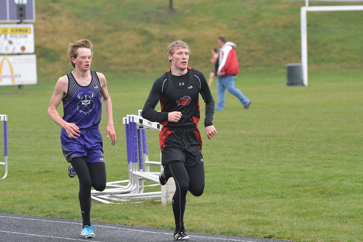 CHARLO RUNNER Wills Degrandpre competes with Hot Springs&#146; James DeTienne in the 1,600-meter relay Thursday afternoon at Polson High School. (Jason Blasco/Lake County Leader)