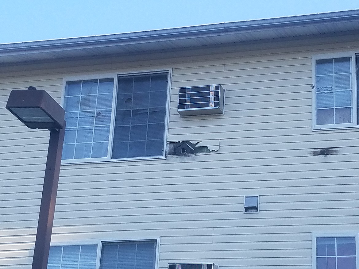 Courtesy photo
Christine Bateman, who lives in the Silver Lake Apartments complex on Wilbur Avenue in Coeur d&#146;Alene, took this photo of damage to the exterior of the apartment where police had a standoff Tuesday evening with James L. Crile, who was wanted for probation violations, including violation of a no-contact order.