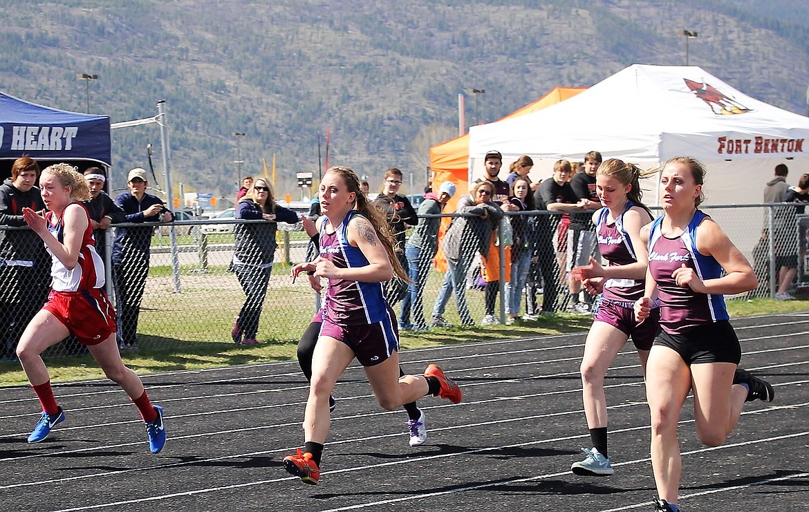 Clark Fork teammates Kathryn Parkin (left) Emmah Baughman (middle) Margaret Parkin (right) run the 100 meter dash during the Seeley-Swan Invitational in Frenchtown on Saturday. (Kathleen Woodford/Mineral Independent).