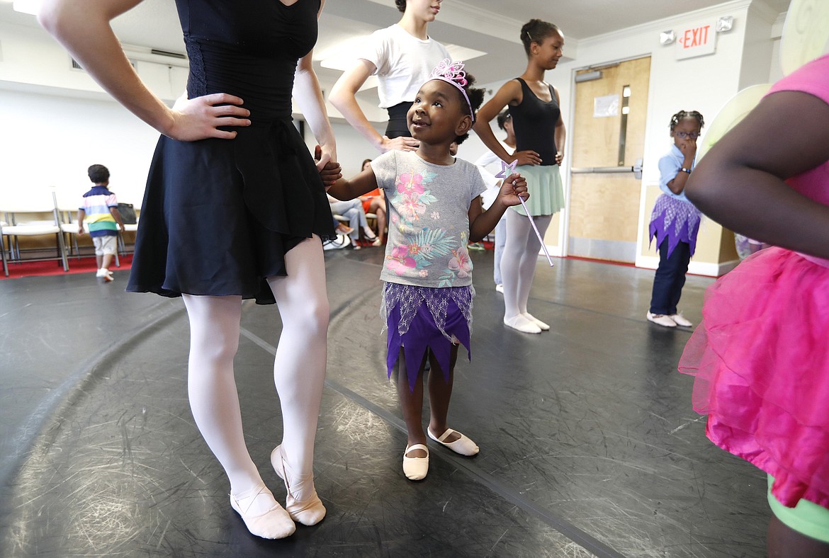 Ethan Hyman/Raleigh News &amp; Observer - Zimora Palmer, 4, holds onto the hand of Addison Spey, with the Cary Ballet Company, during Plie All Day, an outreach program that hopes to bring dance to women's shelters throughout the Triangle. The program spent Thursday, April 20, 2017, at the women's shelter for the Durham Rescue Mission.
