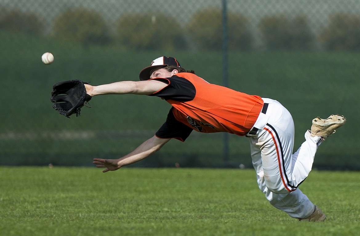 LOREN BENOIT/Press

Post Falls center fielder Cameron McKeown makes a diving catch in the 5A Region 1 semifinal game against Lake City on Monday.