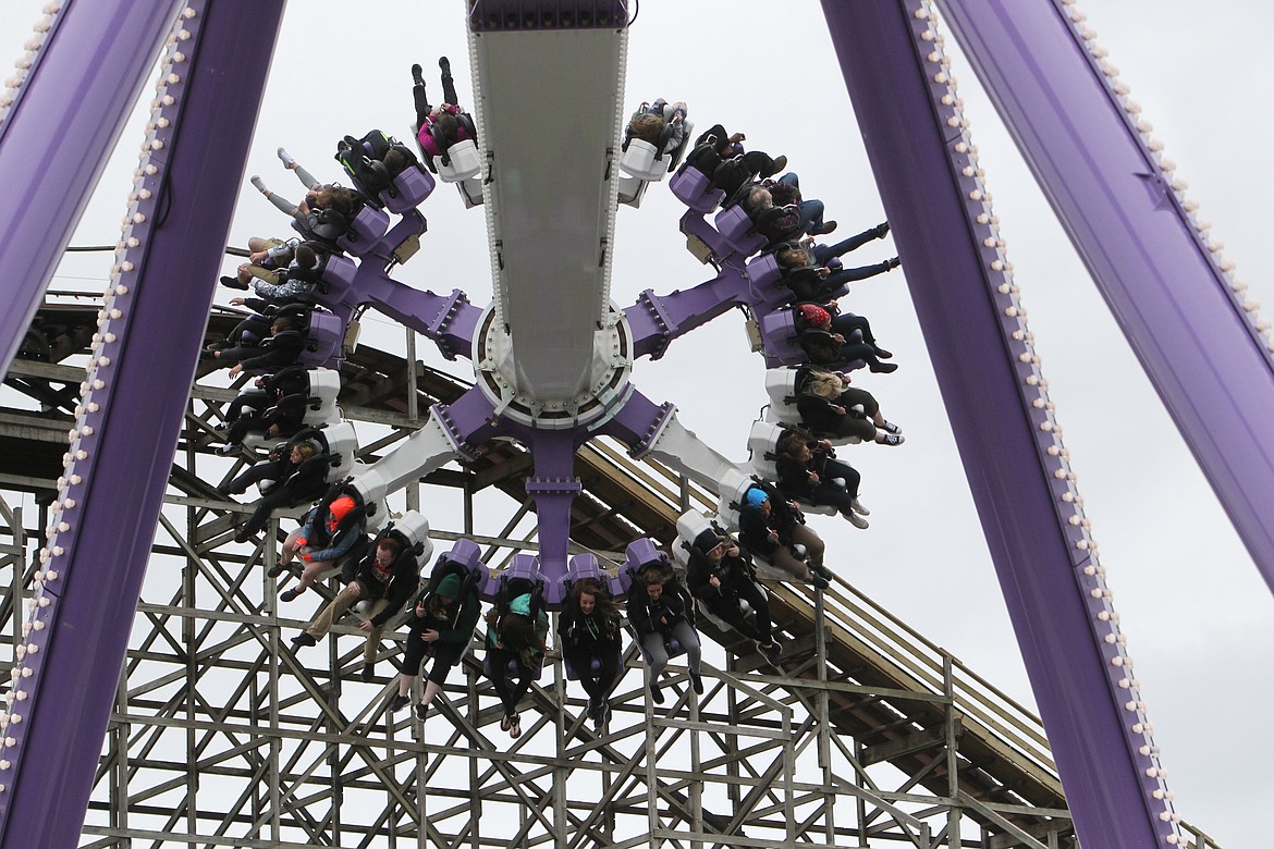 DEVIN HEILMAN/Press
SpinCycle riders kick out their legs Saturday while suspended in the air during Silverwood's first day of the 2017 season. More than 3,000 guests visited the park in spite of rain and chilly temperatures in the 40s.