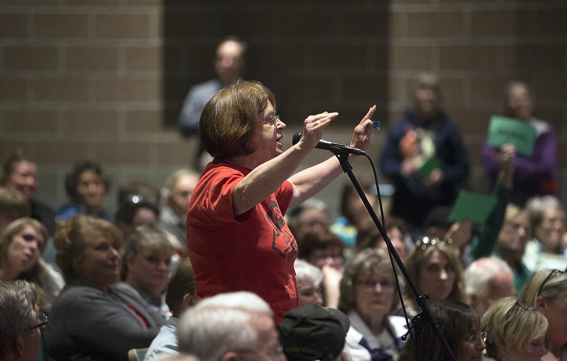 LISA JAMES/PressLinda Sanders asks Idaho Congressman Raul Labrador, (R), how he can deny the science of climate change at the town hall he hosted at Lake City High School in Coeur d'Alene on Friday night.
