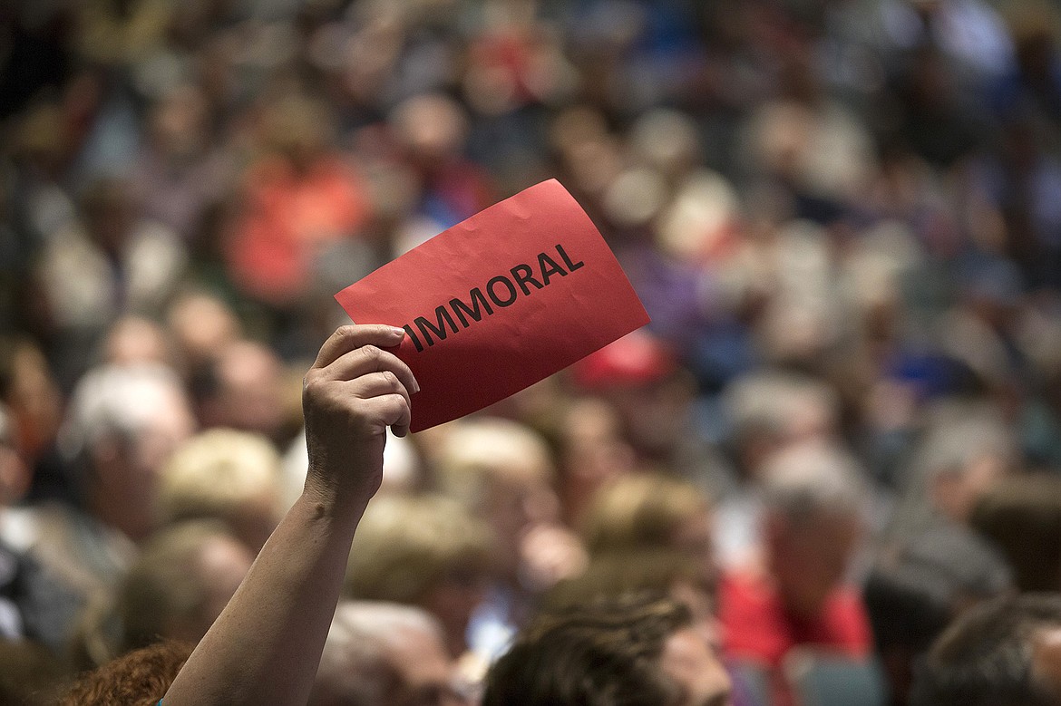 Audience members held up red or green cards that read &#147;immoral&#148; or &#147;moral&#148; as questions were asked and opinions expressed.