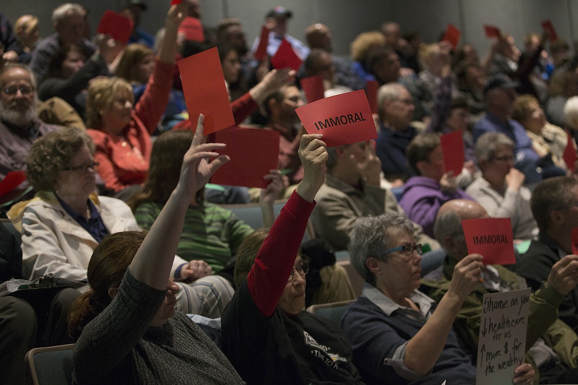 LISA JAMES/PressAudience members held up red or green signs that read &quot;immoral&quot; or &quot;moral&quot; as questions were asked and opinions expressed at Congressman Raul Labrador's town hall at Lake City High School in Coeur d'Alene on Friday night.