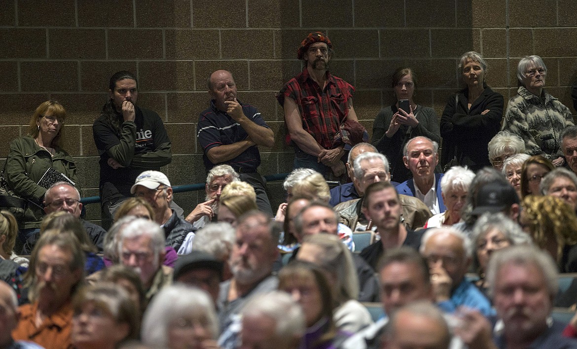 LISA JAMES/PressAudience members listen as Idaho Congressman Raul Labrador, (R) responds to questions as speakers line up against the wall to wait their turn during the town hall he hosted at Lake City High School in Coeur d'Alene on Friday night.