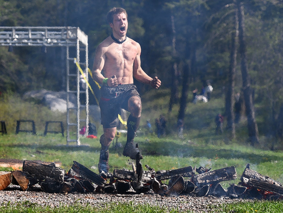 The winner of the Montana Spartan Race Beast jumps over the fire barrier at the finish line on Saturday. (Aaric Bryan/Daily Inter Lake)