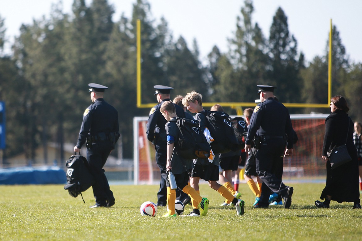 KRISTEN McPEEK/Press file
Members of the Coeur d&#146;Alene Police Department walk across the field after a U-12 soccer game at Coeur d&#146;Alene High School on Saturday, May 9, 2015. Sgt. Moore&#146;s son Dylan, played and scored the first goal of the game held the same day as his father's funeral.