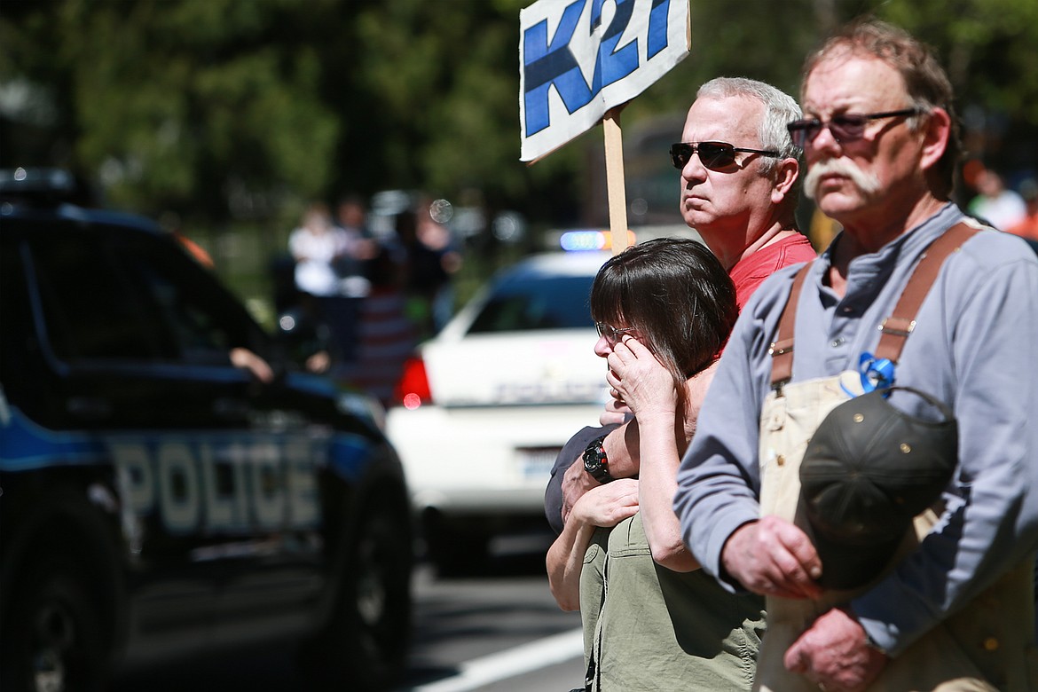 KRISTEN McPEEK/Press file
Sally and Steven Hicks hold a K27 sign outside Forest Cemetery in Coeur d'Alene during the funeral procession for Sgt. Greg Moore on May 9, 2015.