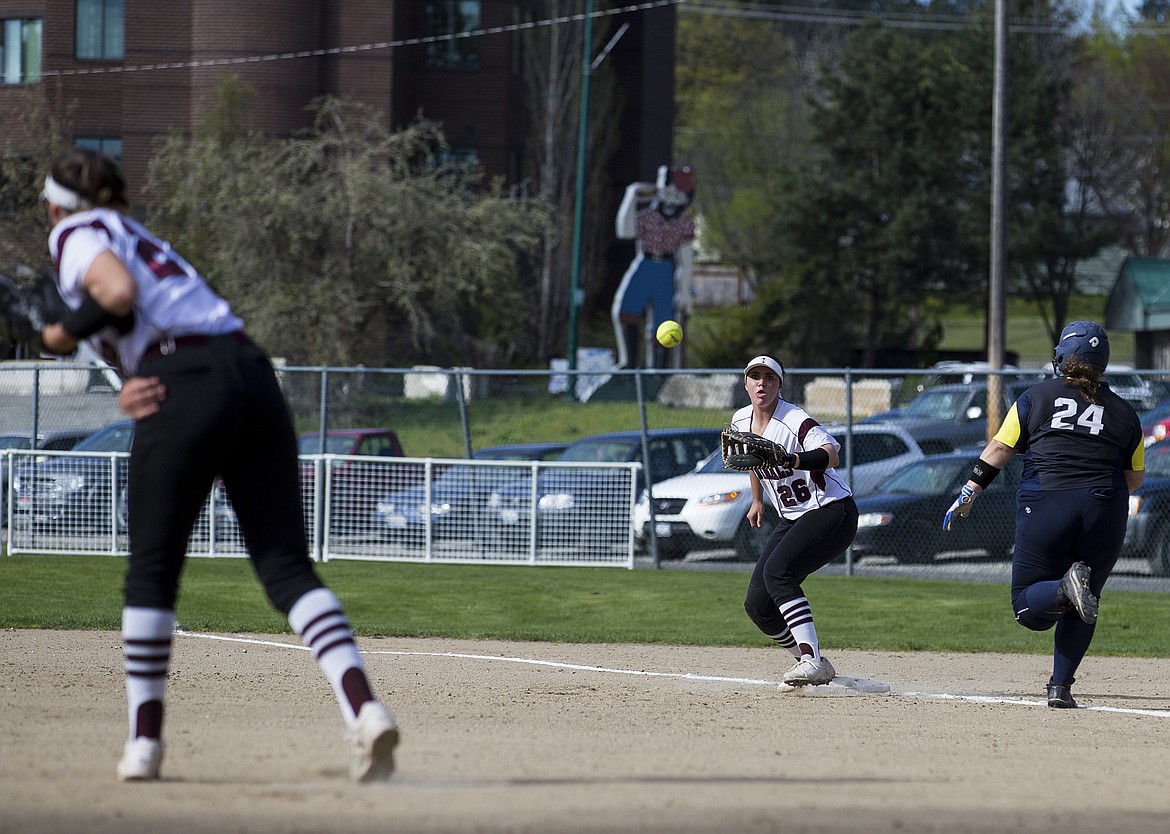 LOREN BENOIT/PressNorth Idaho College first baseman Kennedy Anderson takes a throw from Kayla Moore in a game against College of Spokane at Memorial Field Wednesday afternoon.