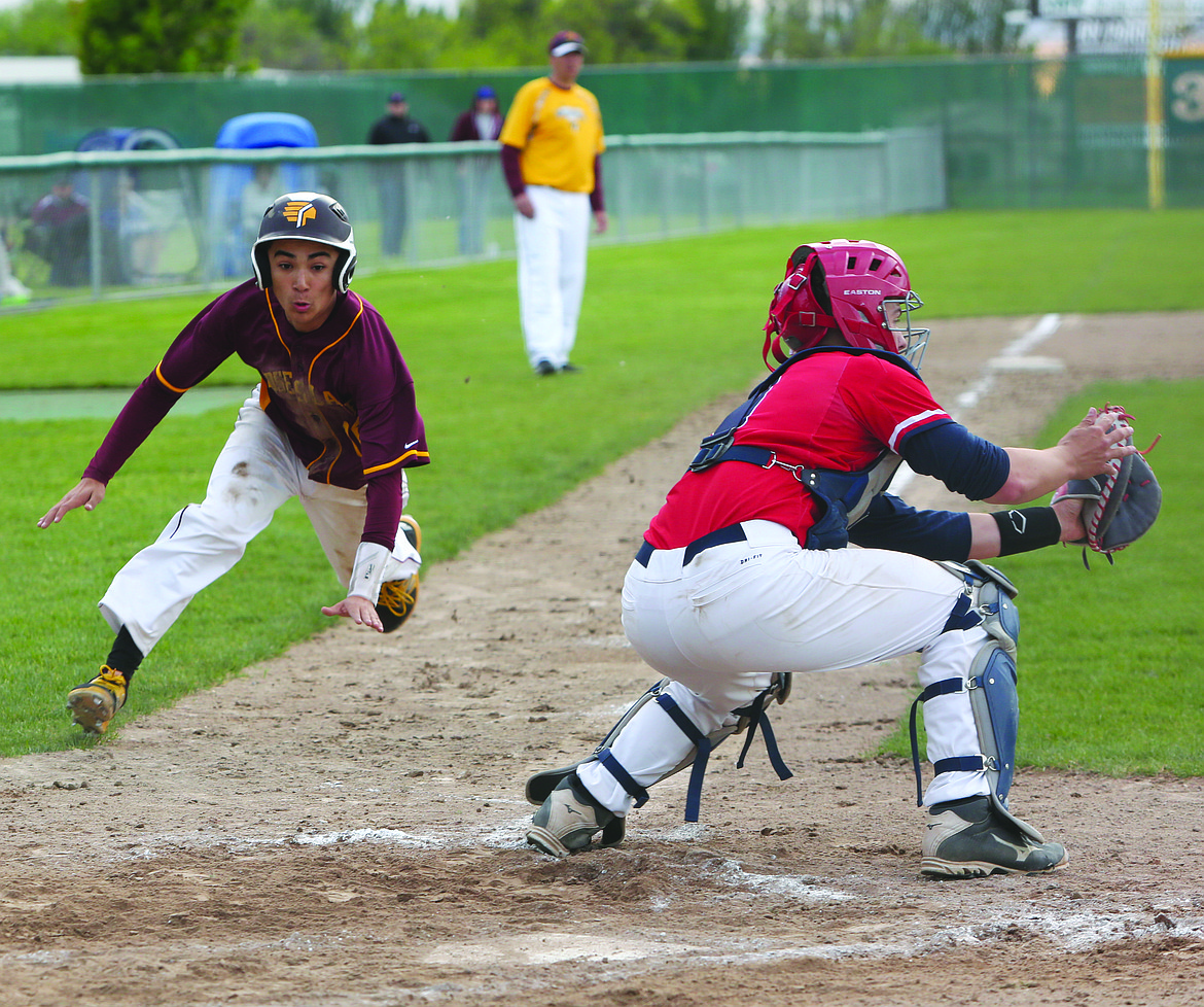 Connor Vanderweyst/Columbia Basin Herald
Moses Lake's Cody Alvarado (left) begins his slide home against Eisenhower.