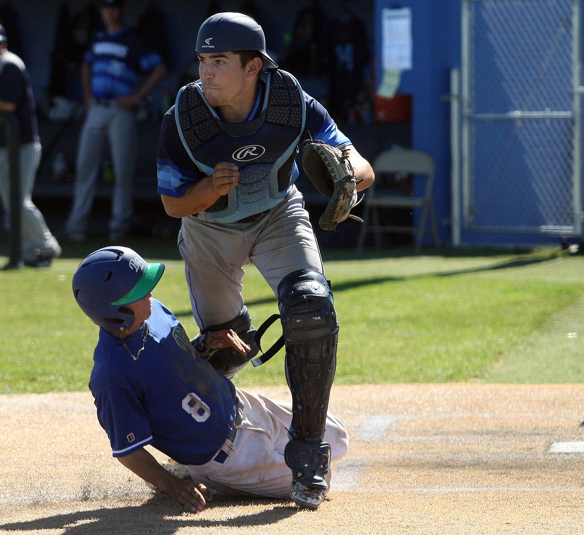 Rodney Harwood/Columbia Basin HeraldBig Bend's Daulton Kvenvold (8) scores the winning run in the first game of Wednesday's NWAC East doubleheader with Columbia Basin as Hawks catcher Mark Jones waits for the throw.