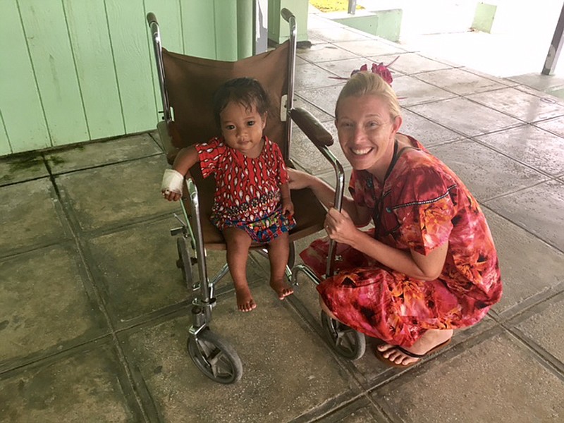 Kasey Patton with a child at the hospital in Majuro.