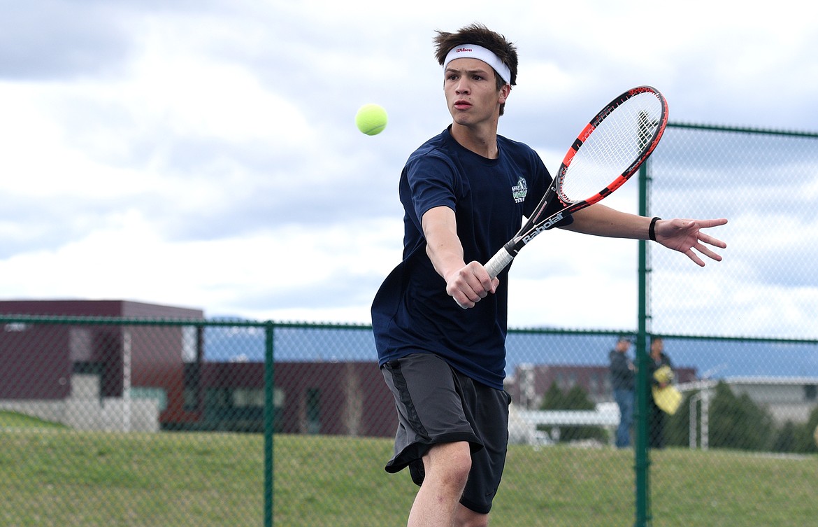 Glacier's Holland Blalack charges the net in his match against Flathead's Ridge Lemke at Flathead Valley Community College on Tuesday. (Aaric Bryan/Daily Inter Lake)