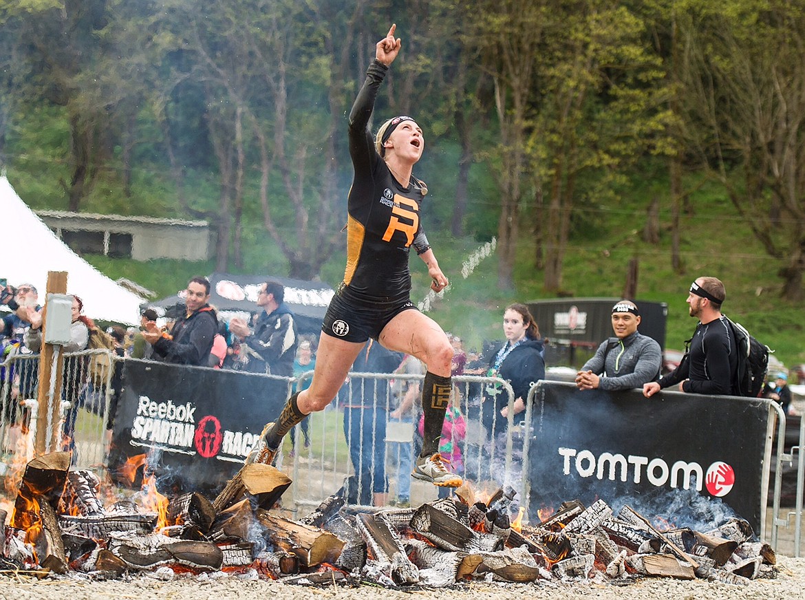 Former North Idaho College softball player Alyssa Hawley points to the sky after clearing her last obstacle on the way to winning the Emerald City Open, the first in the Spartan U.S. Championship series races this season.