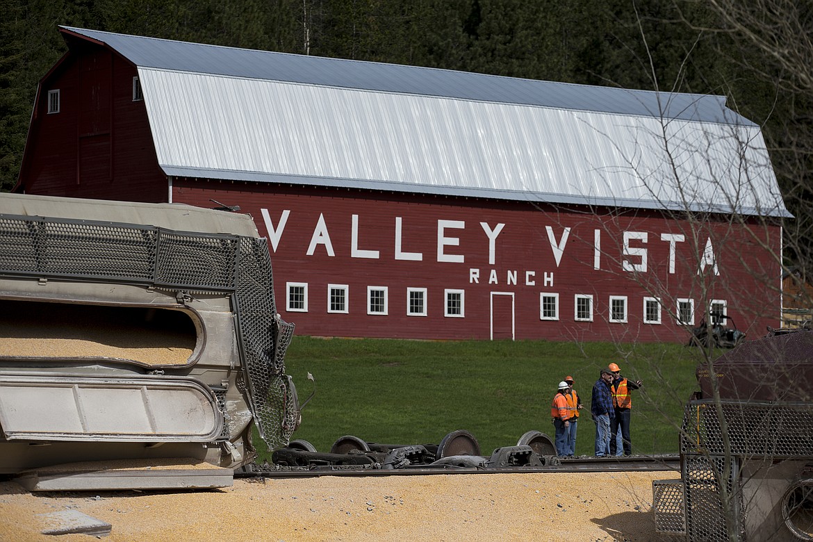 LOREN BENOIT/Press
A BNSF employee speaks with Valley Vista Ranch owner Frank Zimmerman Monday morning at the scene of a derailed train next to Zimmerman&#146;s property. The train was carrying corn.