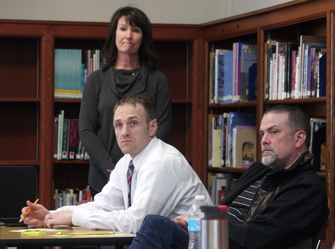 Maggie Anderson of Unite for Youth, standing, Troy Superintendent Jacob Francom, seated left, and Troy Christian Fellowship Pastor Eric Myers listen during a meeting in Troy Tuesday evening, May 2, 2017. (Photo by Elka Wood/TWN)