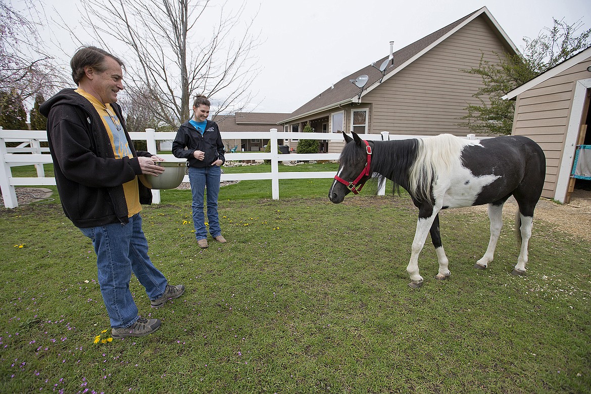 LISA JAMES/PressKevin Pozas and his neighbor Maddy Baker, talk about Sundae's progress since Maddy and her mother found the pony in a reported state of neglect near their Post Falls home this winter. With their help, Pozas and his wife are trying to nurse Sundae back to health. While her overall condition is now healthy, problems with her hooves and legs cause her pain and limit her mobility, calling her quality of life into question.