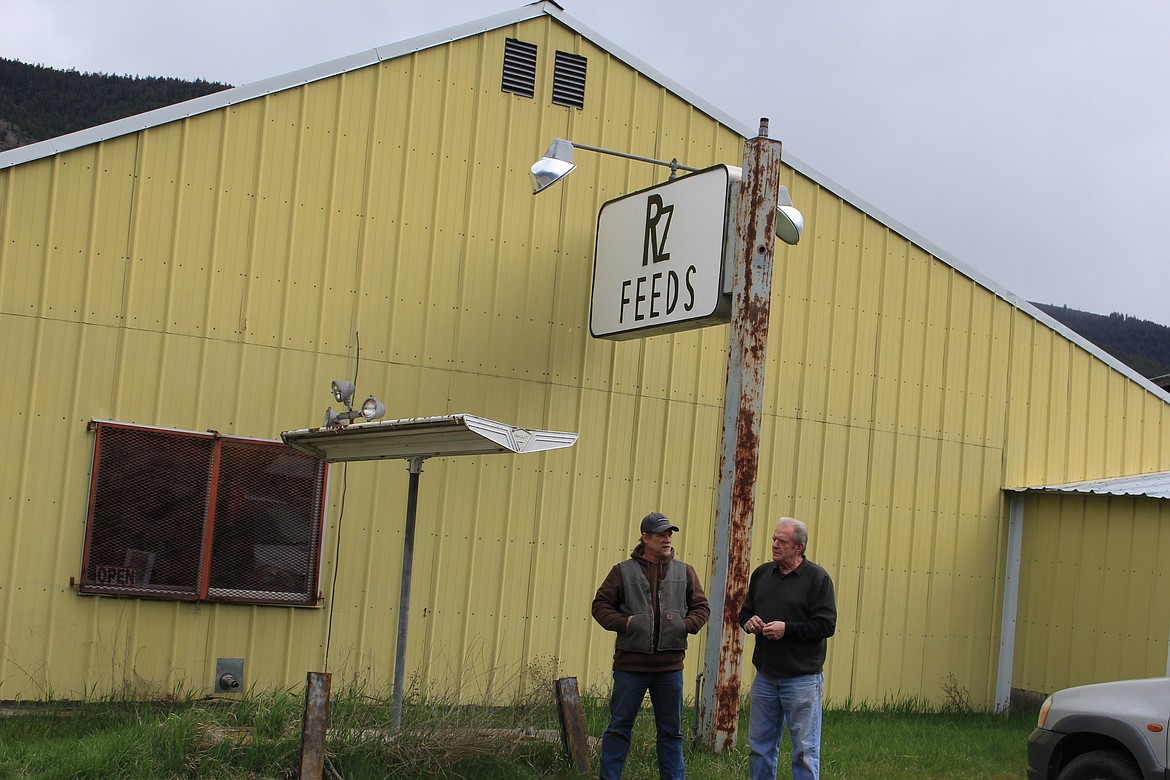 Pete Ratzlaff and Doug Hutchins stand outside RZ Feeds located on Diamond Match Road in Superior. The old yellow building used to be a pizza parlor and a general store. (Kathleen Woodford/Mineral Independent)