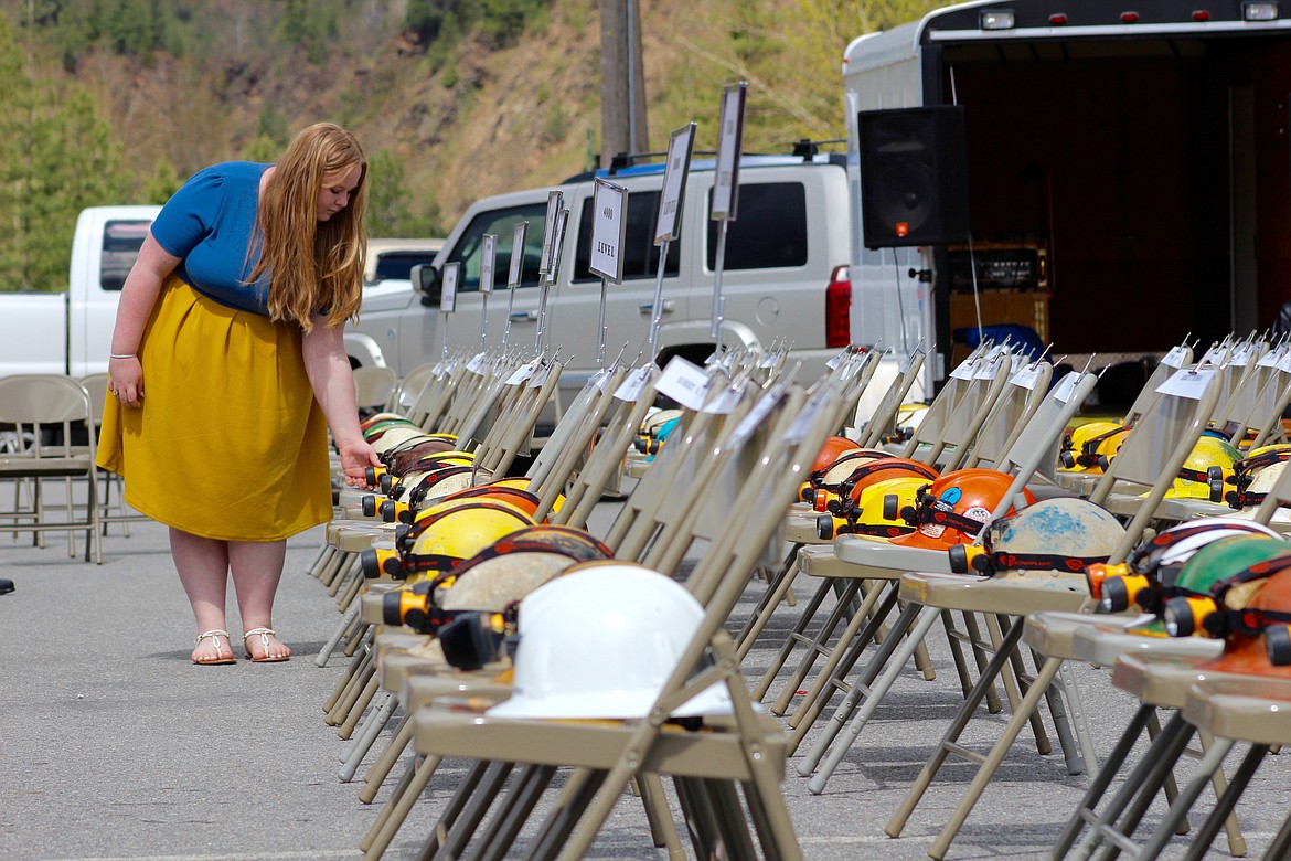 Rylie Gunderson extinguishes the lamps on the helmets of the miners killed as their names are read aloud at Tuesday&#146;s ceremony.