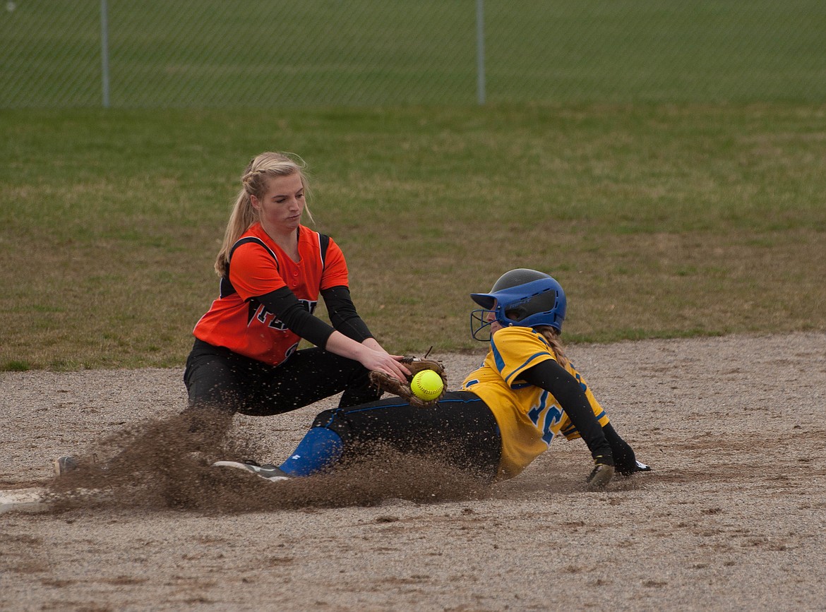 PLAINS-HOT SPRINGS second basemen Stacy Grey attempts to tag out a Libby runner in a recent game.