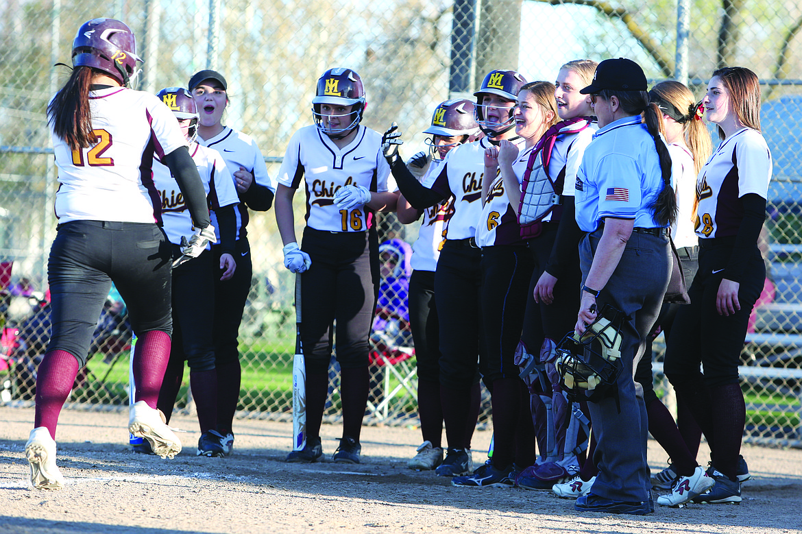 Connor Vanderweyst/Columbia Basin Herald
Brooke Richardson's (12) teammates greet her at home plate after a fourth-inning home run against Wenatchee.