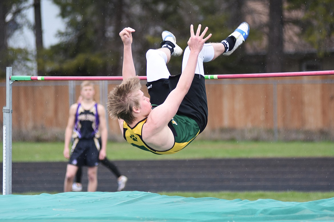 Alex Barker flies through the air during high jump at the A.R.M. Invitational on Saturday.