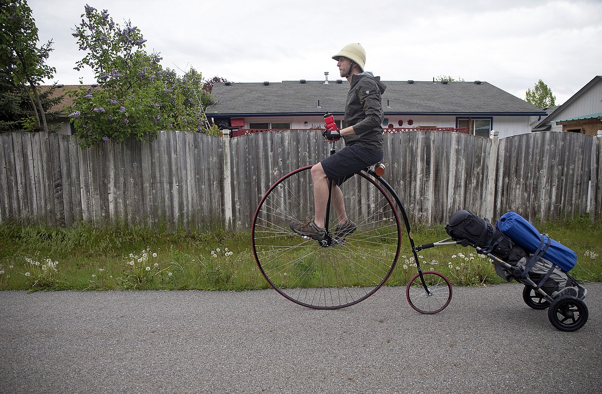 LISA JAMES/PressLocal adventurer Julian Redman rides his penny-farthing bicycle on the bike path near his apartment off of Kathleen Ave. in Coeur d'Alene on Wednesday. Redman will be embarking on a cross-country trip Friday from San Francisco, following the path of Thomas Stevens, the first person to ride a bike across America in 1884. Redman's bicycle is a custom built replica of the bike Stevens rode.