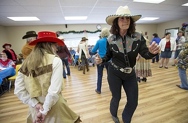 LISA JAMES/Press
Kathleen Falco, right, and Lyn Haney impart some attitude as they line dance to hip-hop with fellow members of BABs (Bayview Athol Belmont) during their Wild West Social at the community center in Bayview on Tuesday