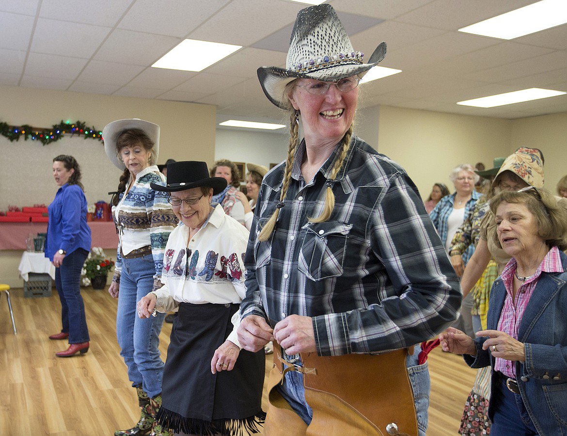 LISA JAMES/PressShirley McFaddan, right, and others line dance as fellow members of BAB (Bayview Athol Belmont) look on during their Wild West Social at the community center in Bayview on Tuesday