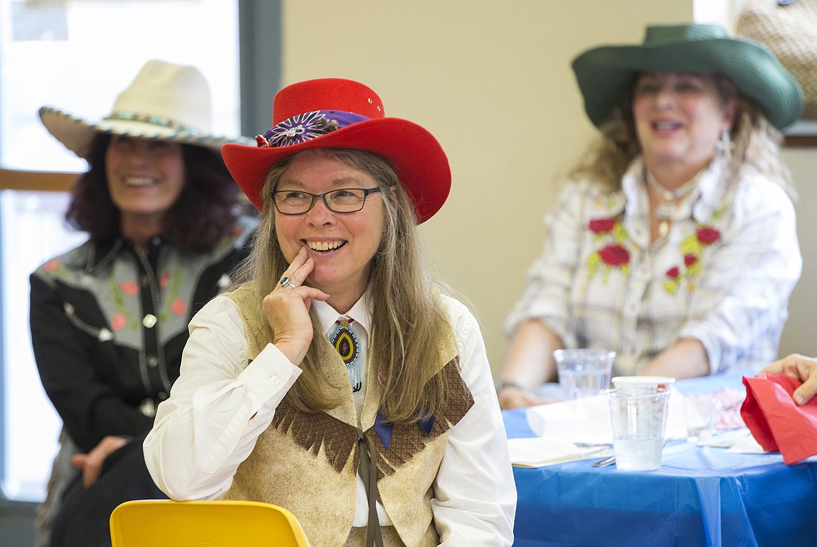 LISA JAMES/Press
Lyn Haney, center, flanked by Kathleen Falco, right, and Jenny Prince, laugh as Don Gardner reads cowboy poetry written by school children during BAB&#146;s (Bayview Athol Belmont) Wild West Social at the community center in Bayview on Tuesday.